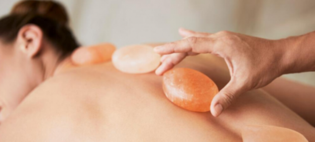 Warm Himalayan salt stone massage therapy in Spokane WA - natural mineral detox and deep muscle tension relief